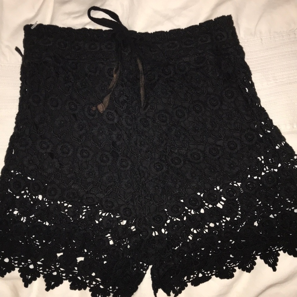 Black overlay lace shorts.